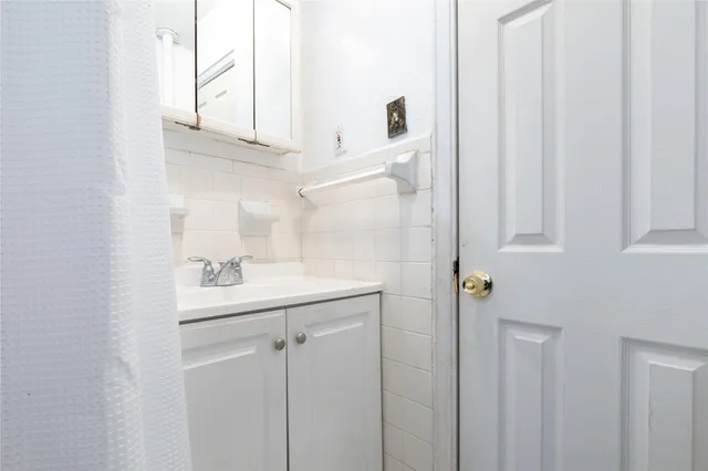 a bathroom with a sink a mirror and shower