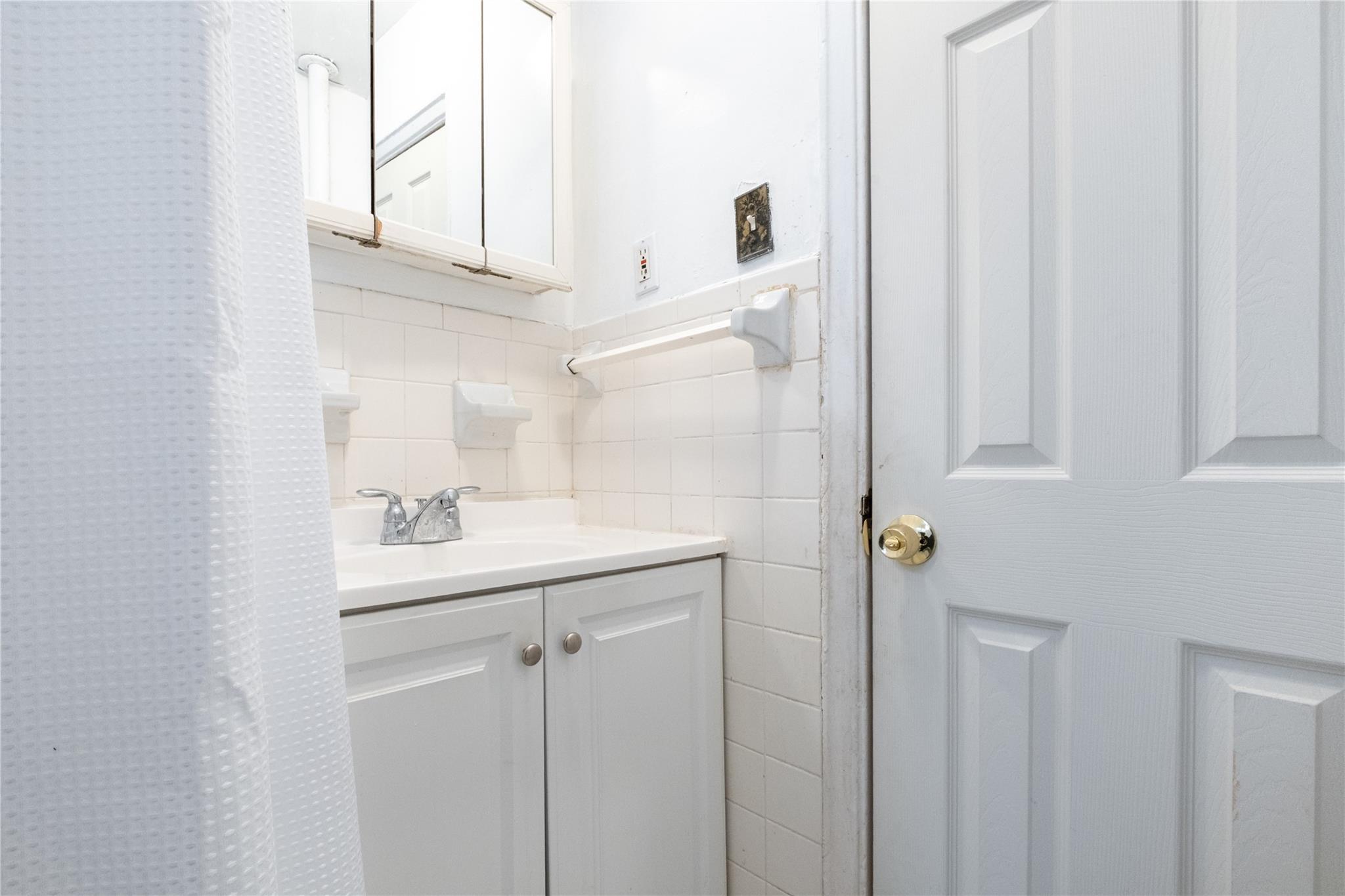 760 Brady Avenue, Unit 417 Bronx, NY 10462 - Photo 12 of 27 a bathroom with a sink a mirror and shower