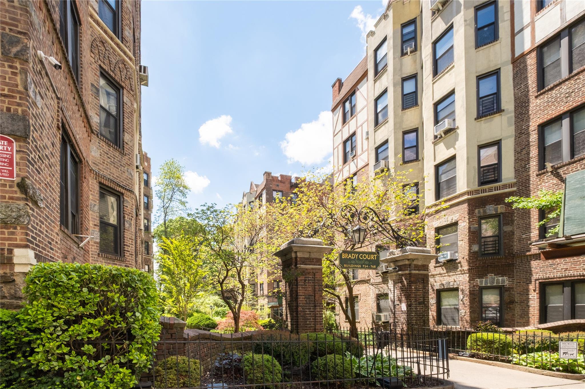 760 Brady Avenue, Unit 417 Bronx, NY 10462 - Photo 2 of 27 a front view of a multi story residential apartment building with a yard
