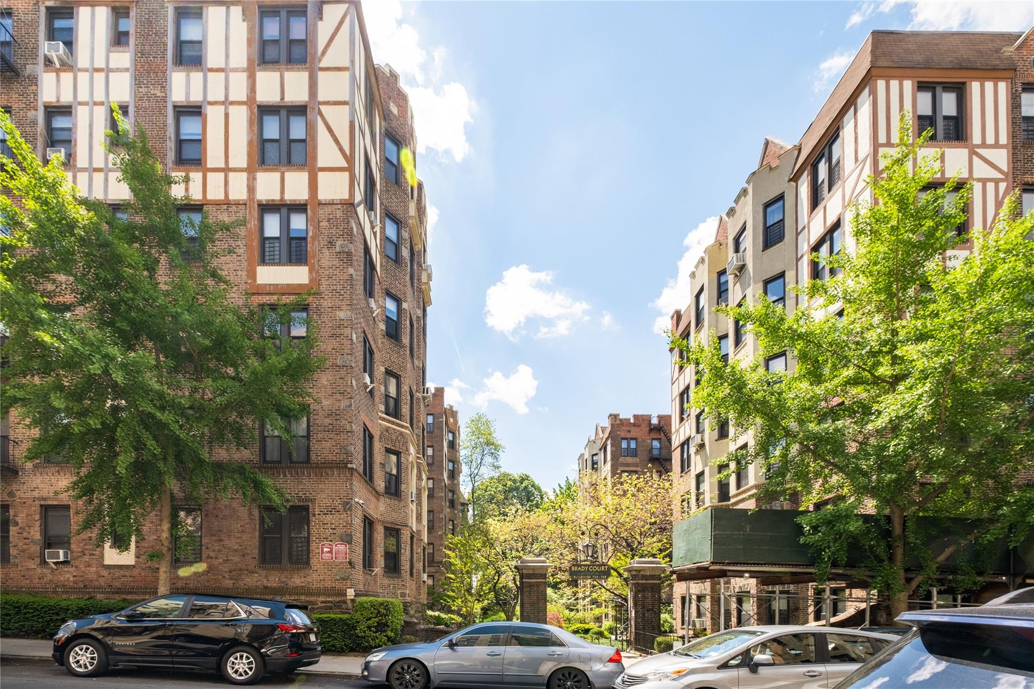 760 Brady Avenue, Unit 417 Bronx, NY 10462 - Photo 3 of 27 a front view of a residential apartment building with a yard