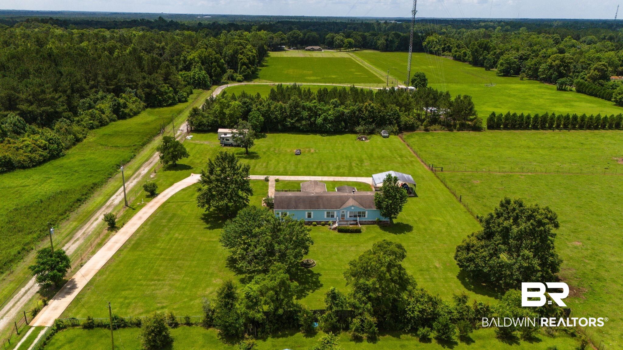 34985b Spring Road South, Unit B Stapleton, AL 36578 - Photo 5 of 31 Expansive property featuring a single-story residence, a long driveway, and surrounding green fields