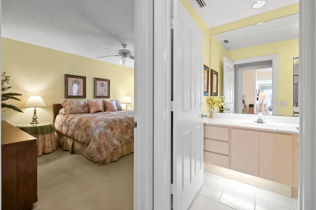 a spacious bedroom with a bed and a chandelier