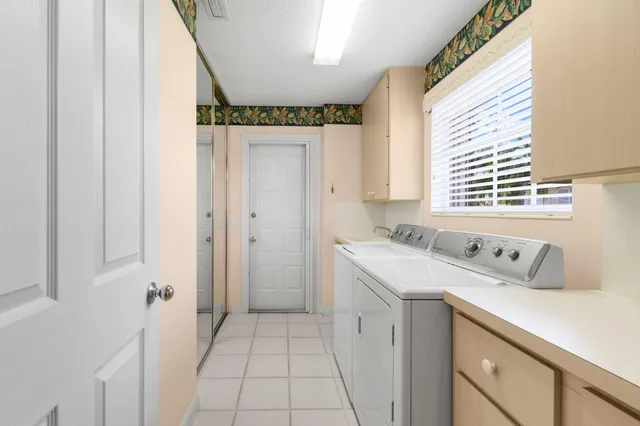 a view of a backyard with table and chairs under an umbrella