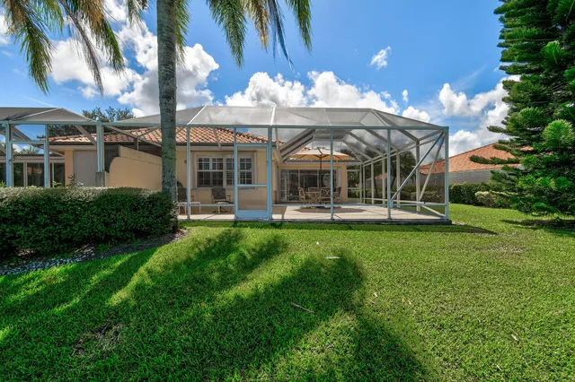 a view of a house with a backyard porch and sitting area
