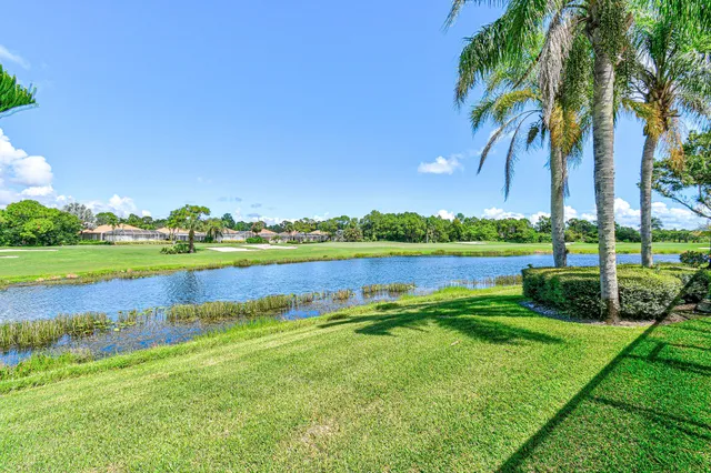 a view of a lake with houses in the back