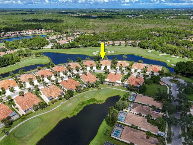 an aerial view of a house with a garden and swimming pool