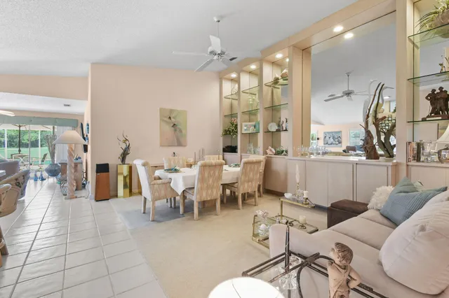 a living room with furniture a large window and a chandelier