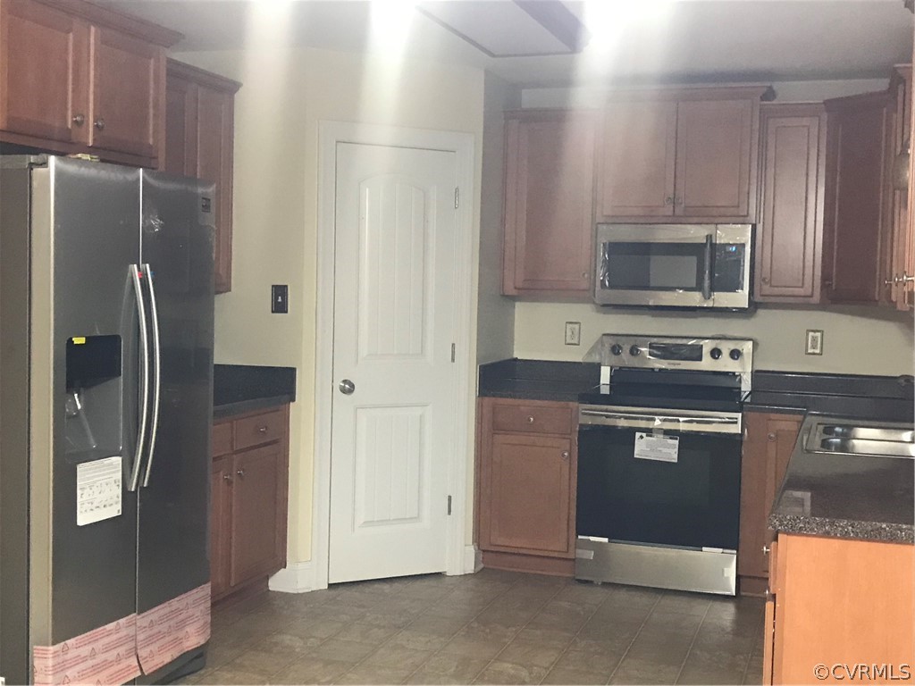 624 Enon Church Road Chester, VA 23836 - Photo 4 of 9 a kitchen with granite countertop a refrigerator and a stove top oven