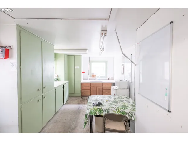 a kitchen view with cabinets and window