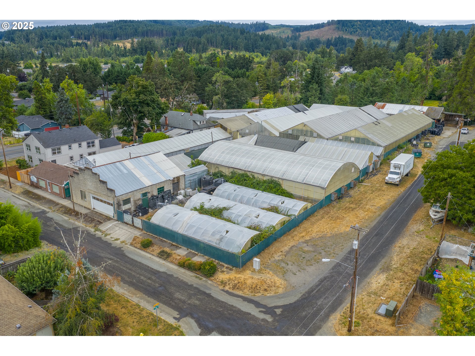 55 Q Street Cottage Grove, OR 97424 - Photo 19 of 36 an aerial view of a house with a garden