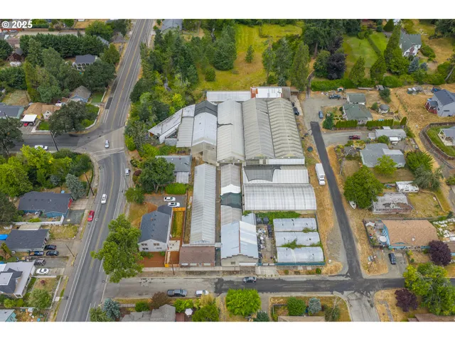 an aerial view of residential houses with outdoor space and street view