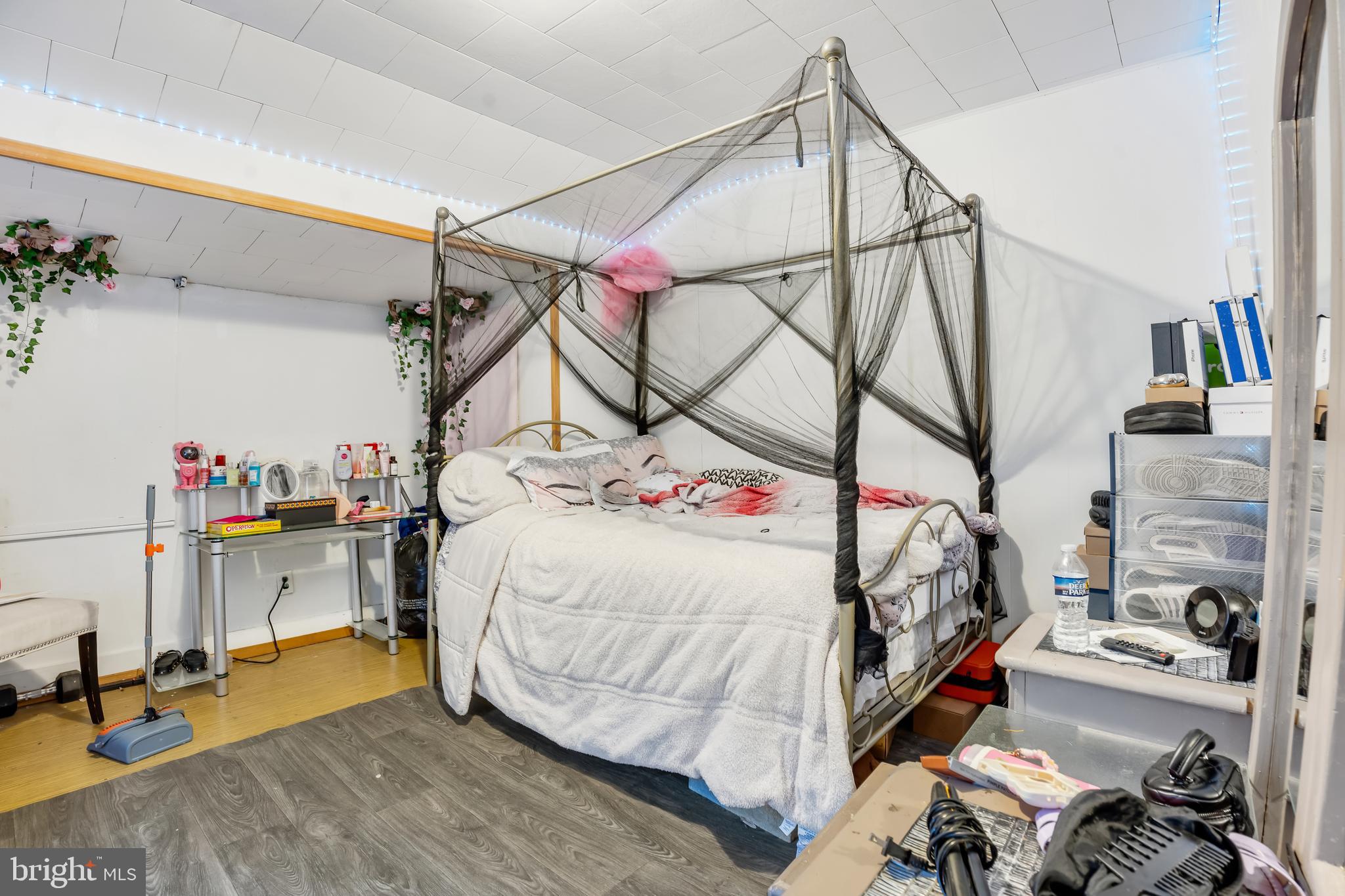 162 7th Street Salem, NJ 08079 - Photo 3 of 5 a bedroom with a bed and a chandelier