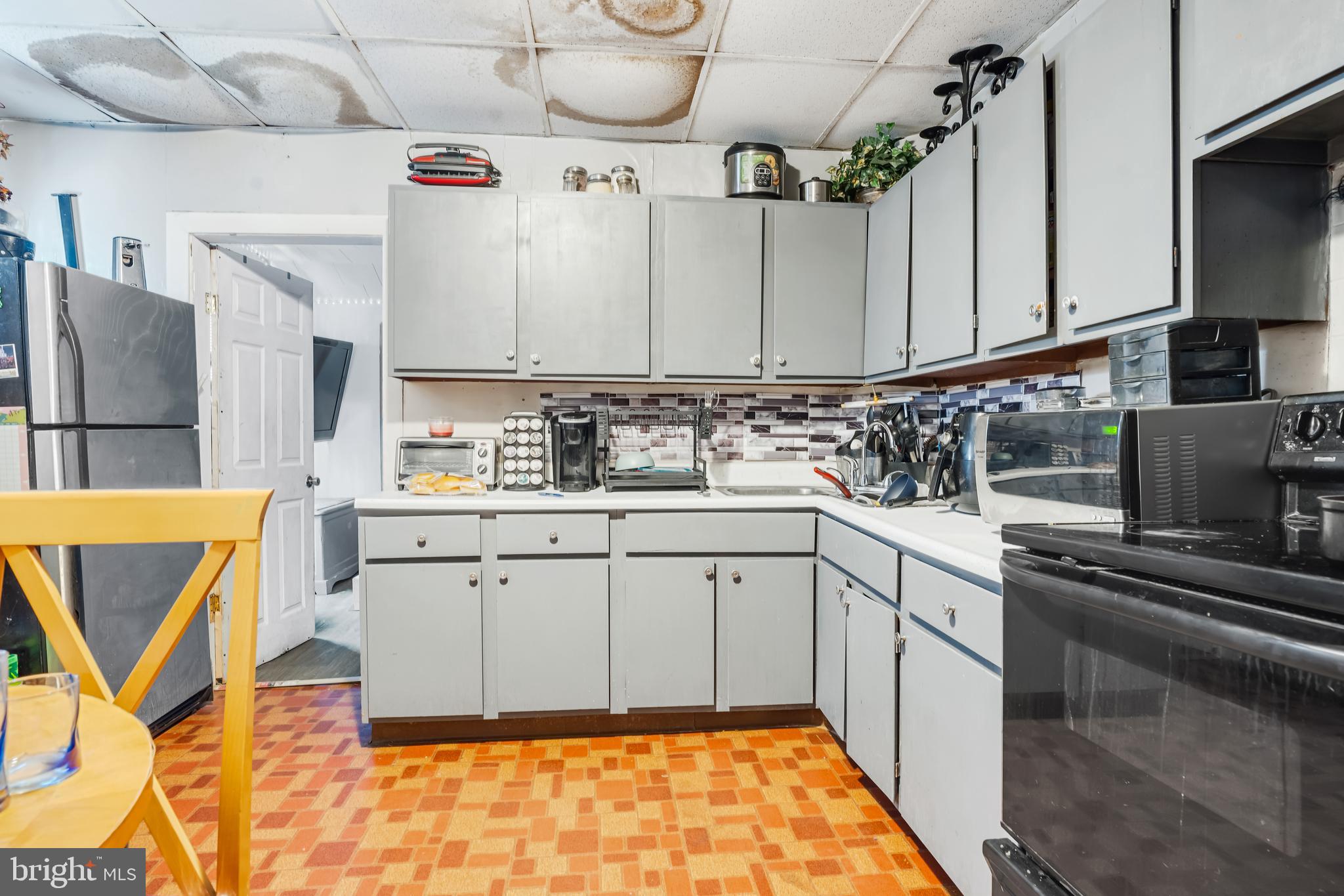 162 7th Street Salem, NJ 08079 - Photo 4 of 5 a kitchen with cabinets appliances and a counter space