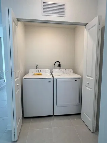 a view of an entrance to house with yard and green space