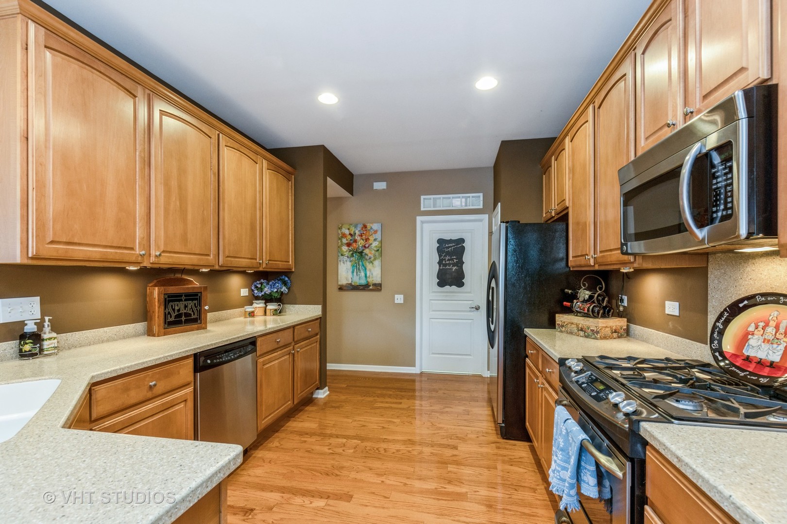 2832 Cascade Falls Circle Elgin, IL 60124 - Photo 7 of 37 a kitchen with stainless steel appliances granite countertop a stove top oven a sink dishwasher and cabinets with wooden floor