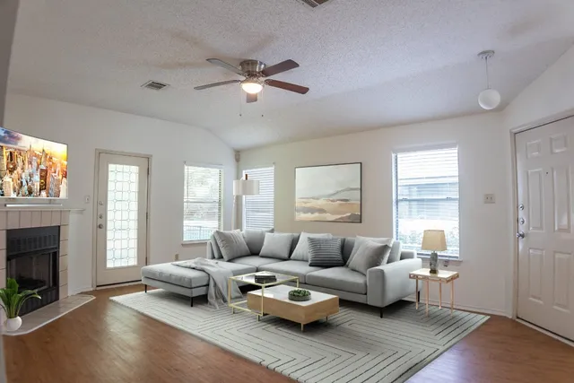 a living room with furniture and a fireplace