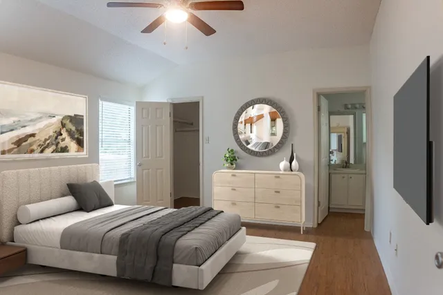 an empty room with wooden floor cabinet and windows