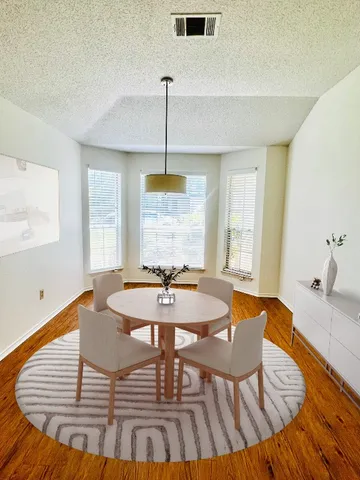 a view of a dining room with furniture window and wooden floor