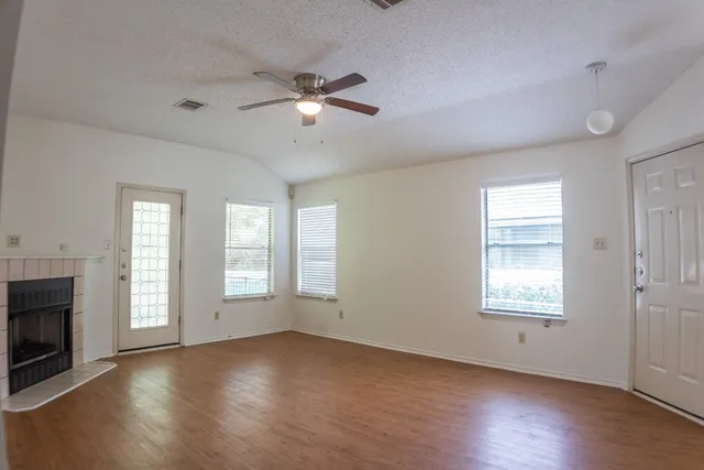 a kitchen with granite countertop a sink a counter top space stainless steel appliances and cabinets