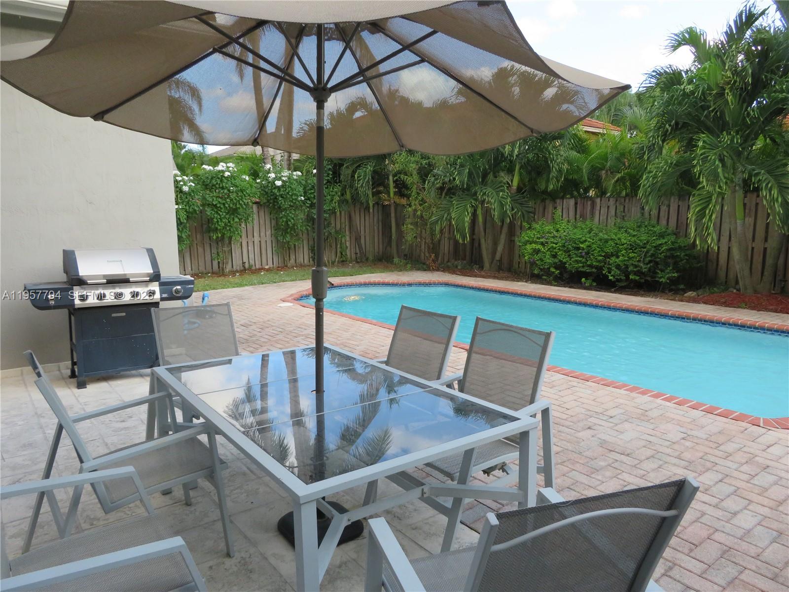 15764 Southwest 101st Street Miami, FL 33196 - Photo 14 of 27 a view of an outdoor sitting area with couch and table
