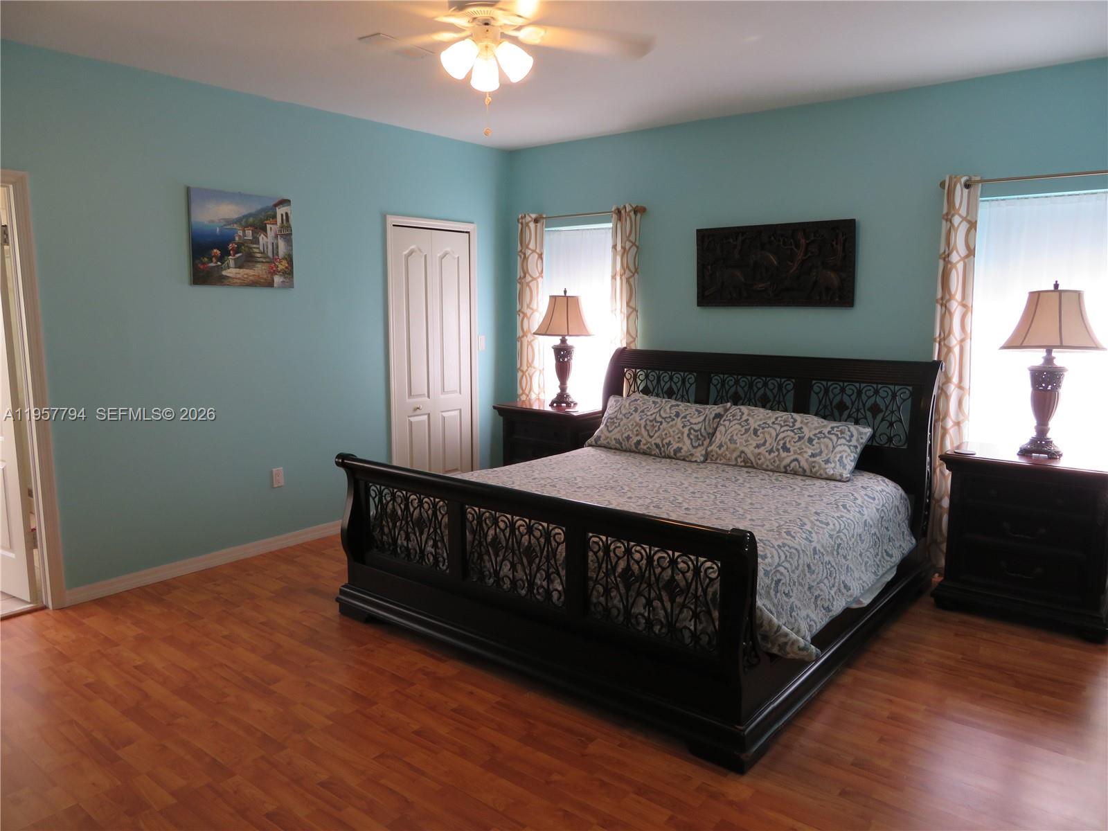 15764 Southwest 101st Street Miami, FL 33196 - Photo 16 of 27 a bed sitting in a bedroom next to a window