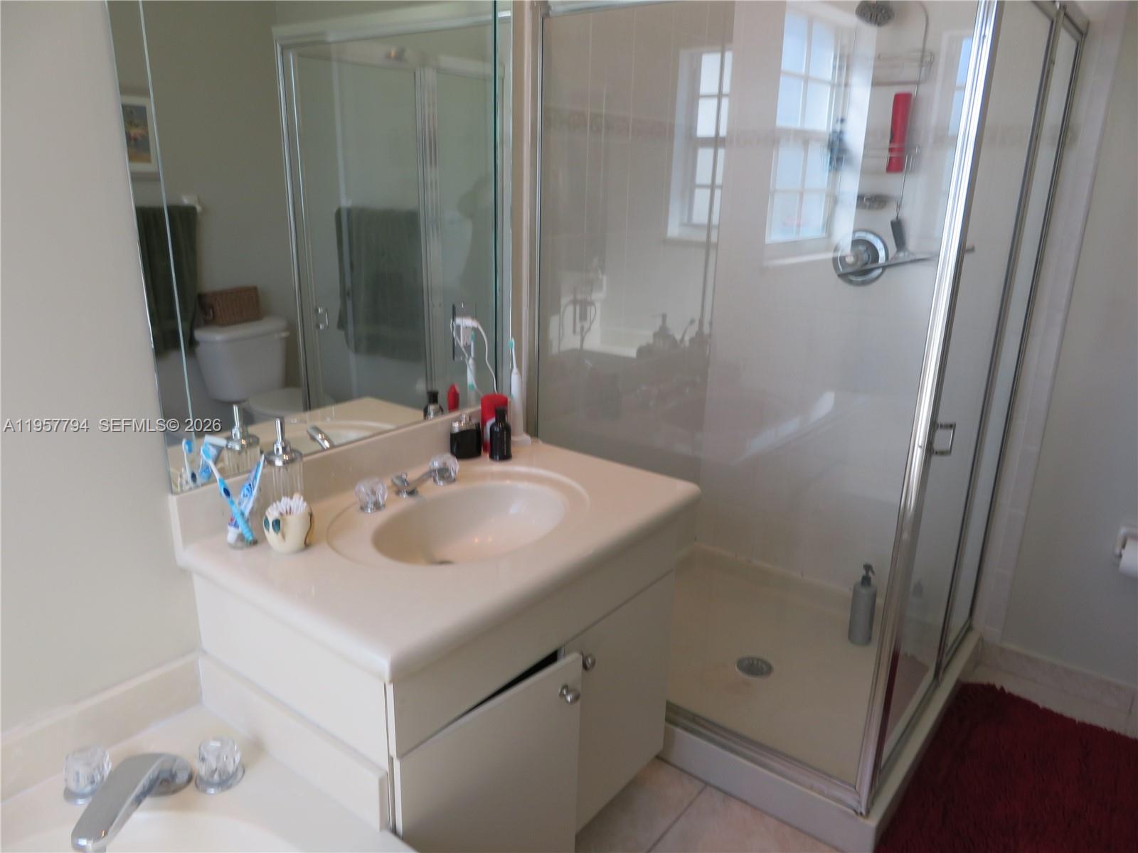 15764 Southwest 101st Street Miami, FL 33196 - Photo 17 of 27 a bathroom with a sink and a mirror