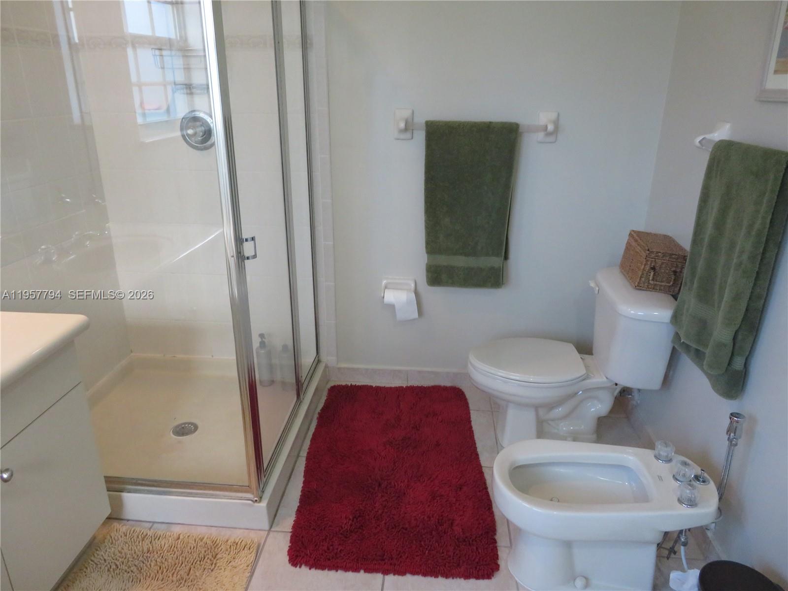 15764 Southwest 101st Street Miami, FL 33196 - Photo 18 of 27 a bathroom with a toilet and a shower