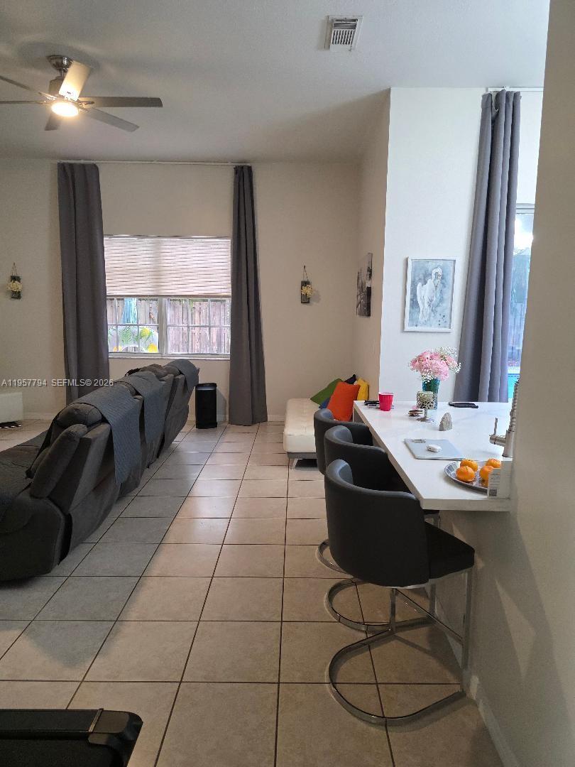 15764 Southwest 101st Street Miami, FL 33196 - Photo 4 of 27 a living room with furniture or couch and a large window