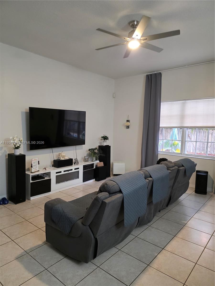 15764 Southwest 101st Street Miami, FL 33196 - Photo 5 of 27 a living room with furniture and a flat screen tv