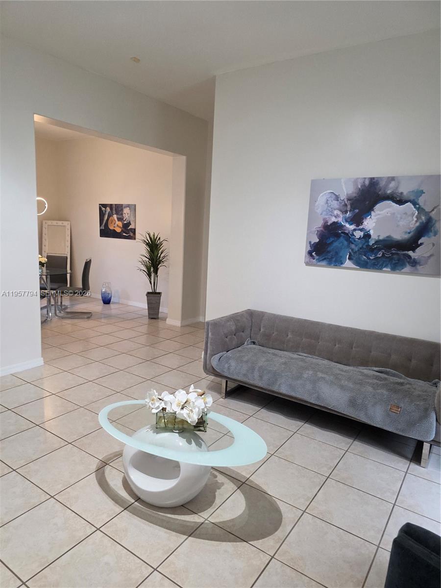 15764 Southwest 101st Street Miami, FL 33196 - Photo 6 of 27 a living room with furniture and a table
