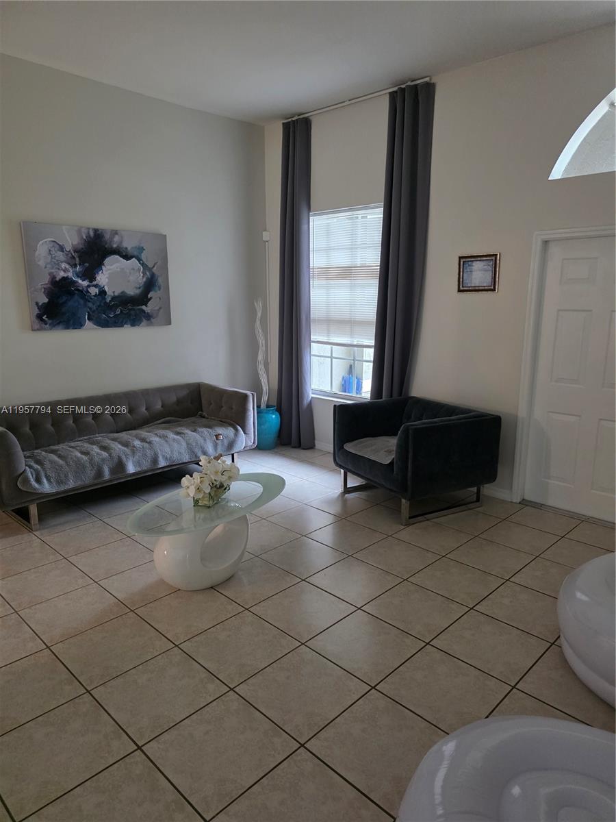 15764 Southwest 101st Street Miami, FL 33196 - Photo 8 of 27 a living room with furniture and a window