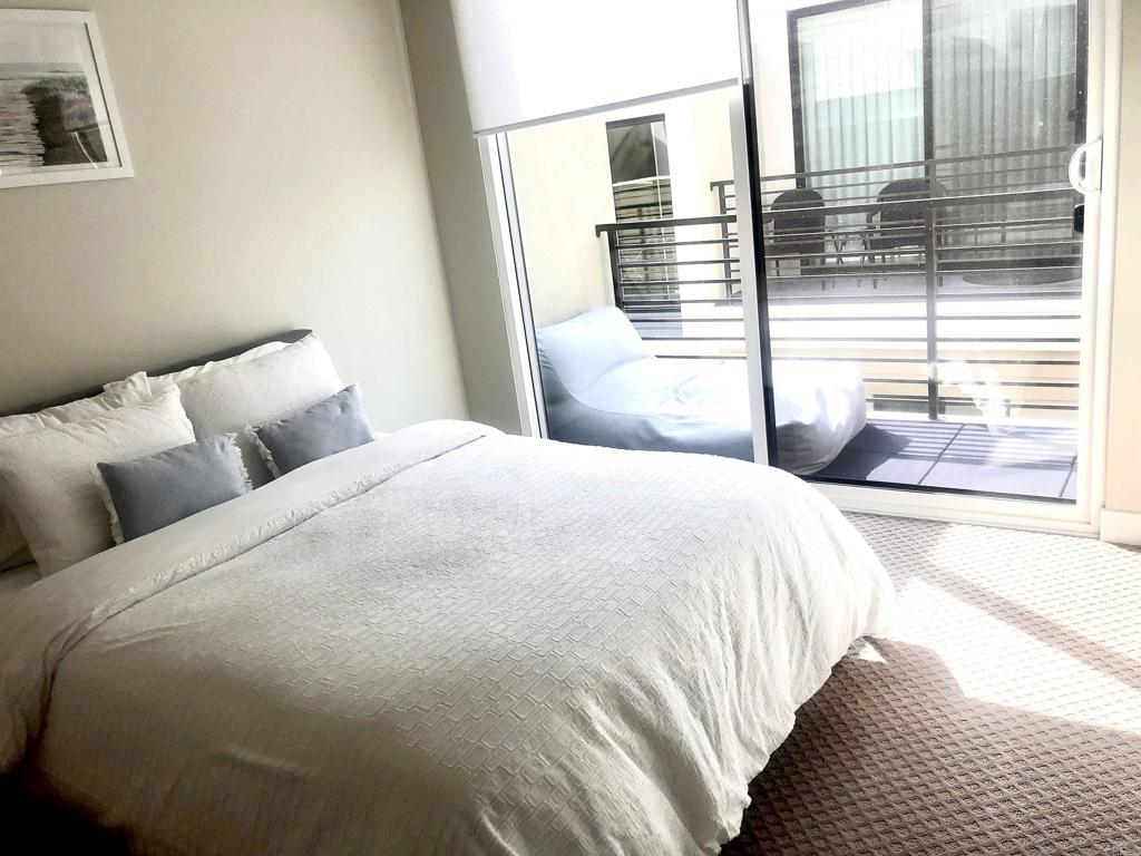 1903 South Myers Street, Unit 3 Oceanside, CA 92054 - Photo 13 of 30 a bedroom with a bed and a large window