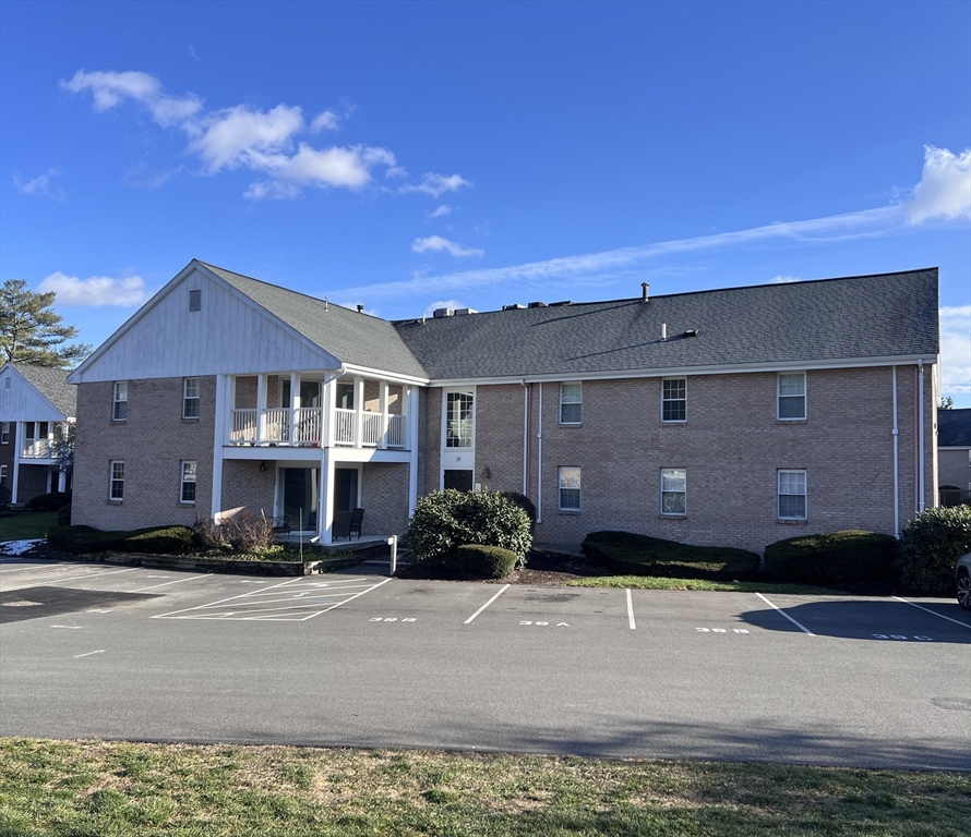 39 Christopher Drive, Unit B Stoughton, MA 02072 - Photo 1 of 38 a front view of a house with a yard