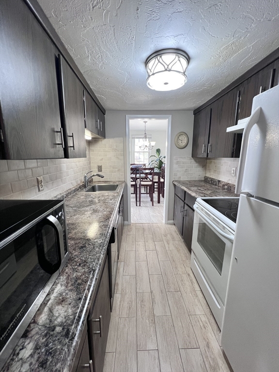 39 Christopher Drive, Unit B Stoughton, MA 02072 - Photo 12 of 38 a kitchen with stainless steel appliances granite countertop a stove and a sink