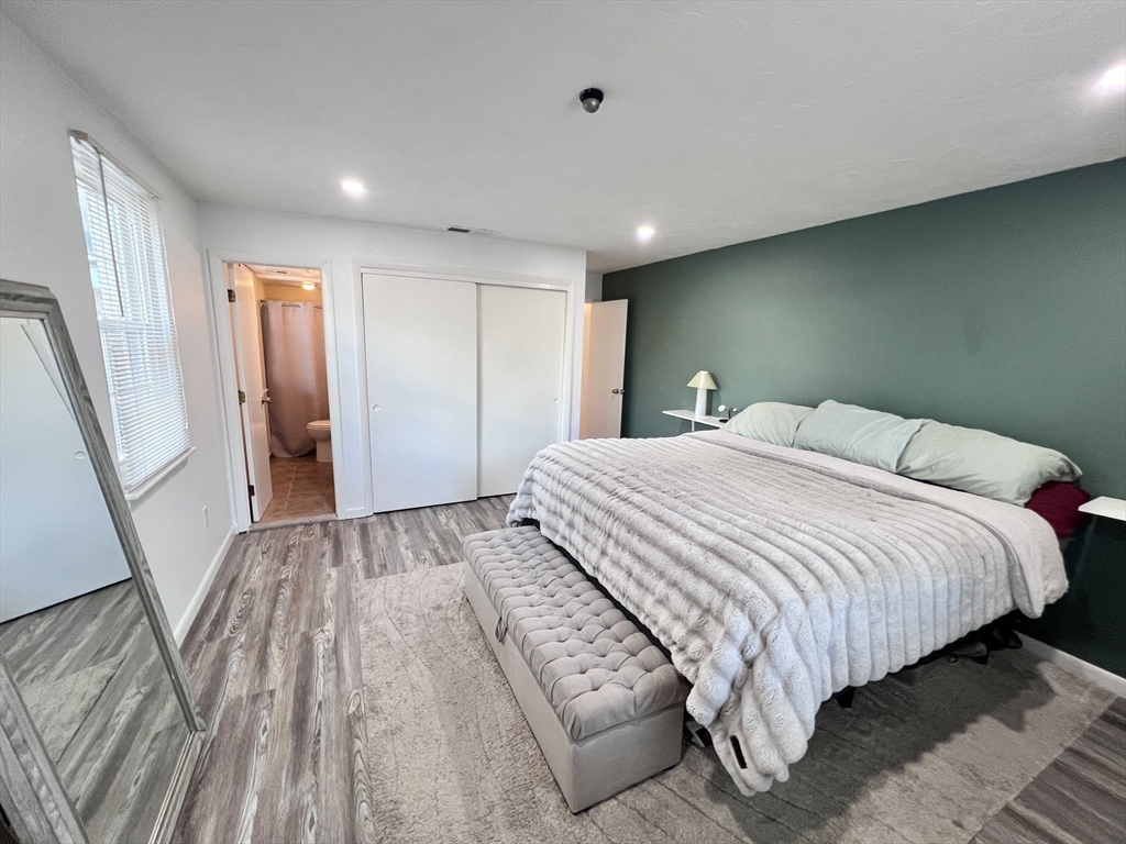 39 Christopher Drive, Unit B Stoughton, MA 02072 - Photo 15 of 38 a bedroom with a bed and a large mirror