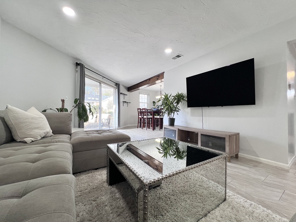 39 Christopher Drive, Unit B Stoughton, MA 02072 - Photo 2 of 38 a living room with furniture and a flat screen tv