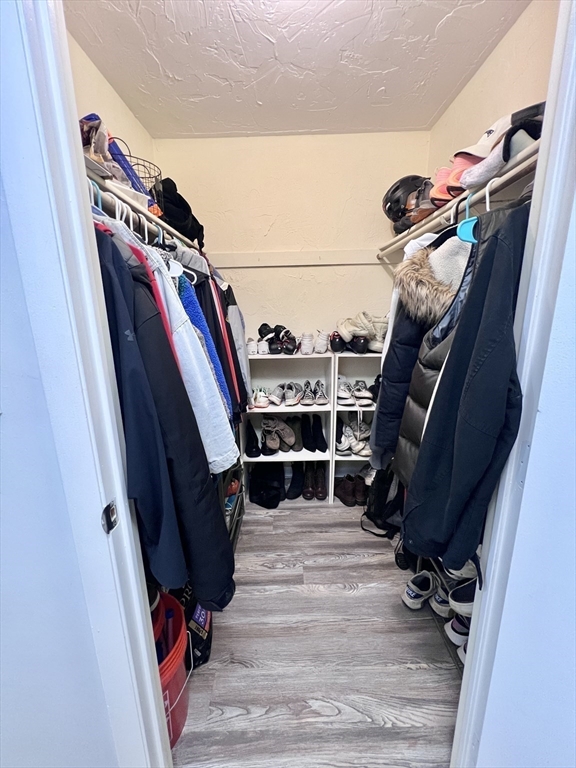 39 Christopher Drive, Unit B Stoughton, MA 02072 - Photo 21 of 38 a view of walk in closet with clothes and shoes