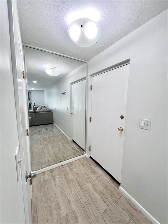 39 Christopher Drive, Unit B Stoughton, MA 02072 - Photo 22 of 38 a view of hallway with stairs and wooden floor