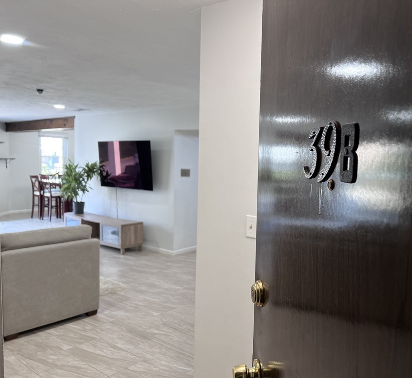 39 Christopher Drive, Unit B Stoughton, MA 02072 - Photo 24 of 38 a living room with furniture and a flat screen tv