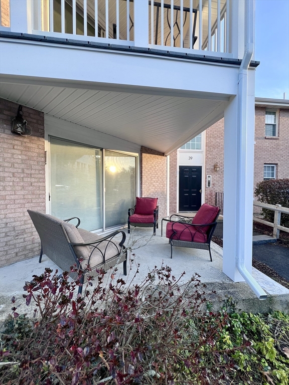 39 Christopher Drive, Unit B Stoughton, MA 02072 - Photo 28 of 38 a backyard of a house with outdoor seating