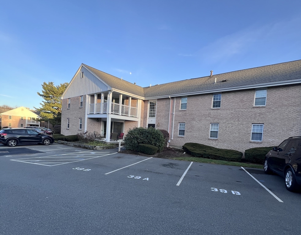 39 Christopher Drive, Unit B Stoughton, MA 02072 - Photo 29 of 38 a front view of a house with a garden