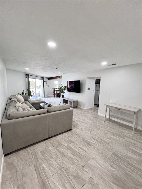 39 Christopher Drive, Unit B Stoughton, MA 02072 - Photo 4 of 38 a living room with furniture and a flat screen tv