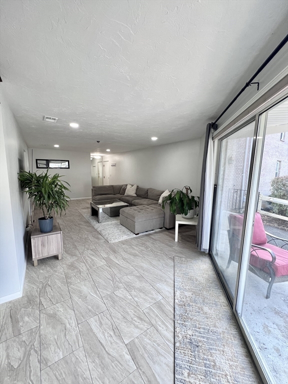 39 Christopher Drive, Unit B Stoughton, MA 02072 - Photo 6 of 38 a living room with furniture and a potted plant