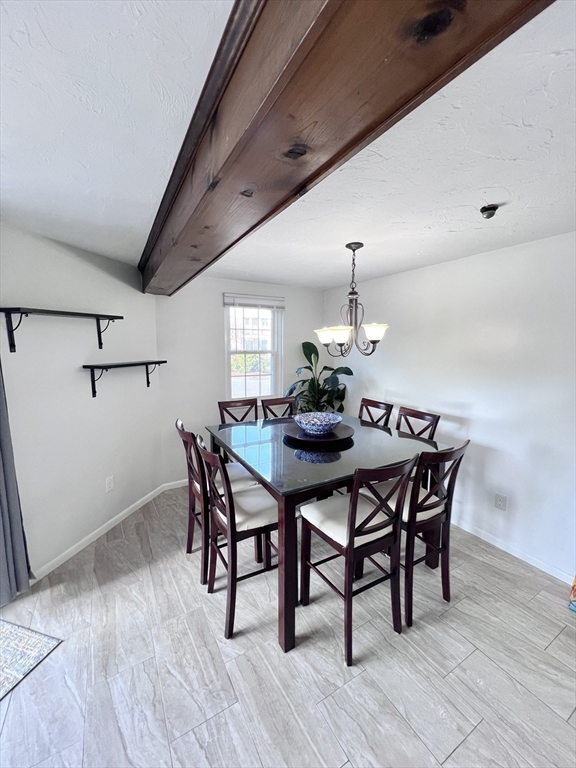 39 Christopher Drive, Unit B Stoughton, MA 02072 - Photo 9 of 38 a dining room with furniture a chandelier and wooden floor