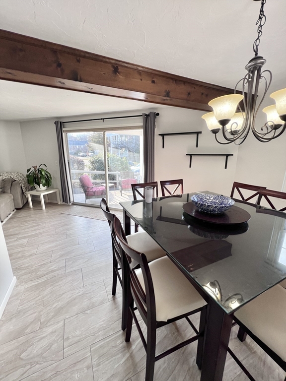 39 Christopher Drive, Unit B Stoughton, MA 02072 - Photo 10 of 38 a view of a dining room with furniture and a large window