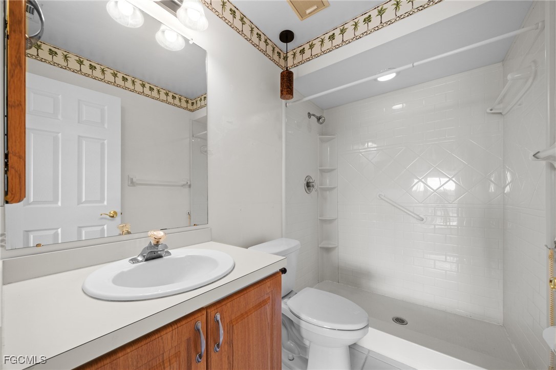 13276 White Marsh Lane, Unit 3533 Fort Myers, FL 33912 - Photo 20 of 31 a bathroom with a sink toilet double vanity and shower