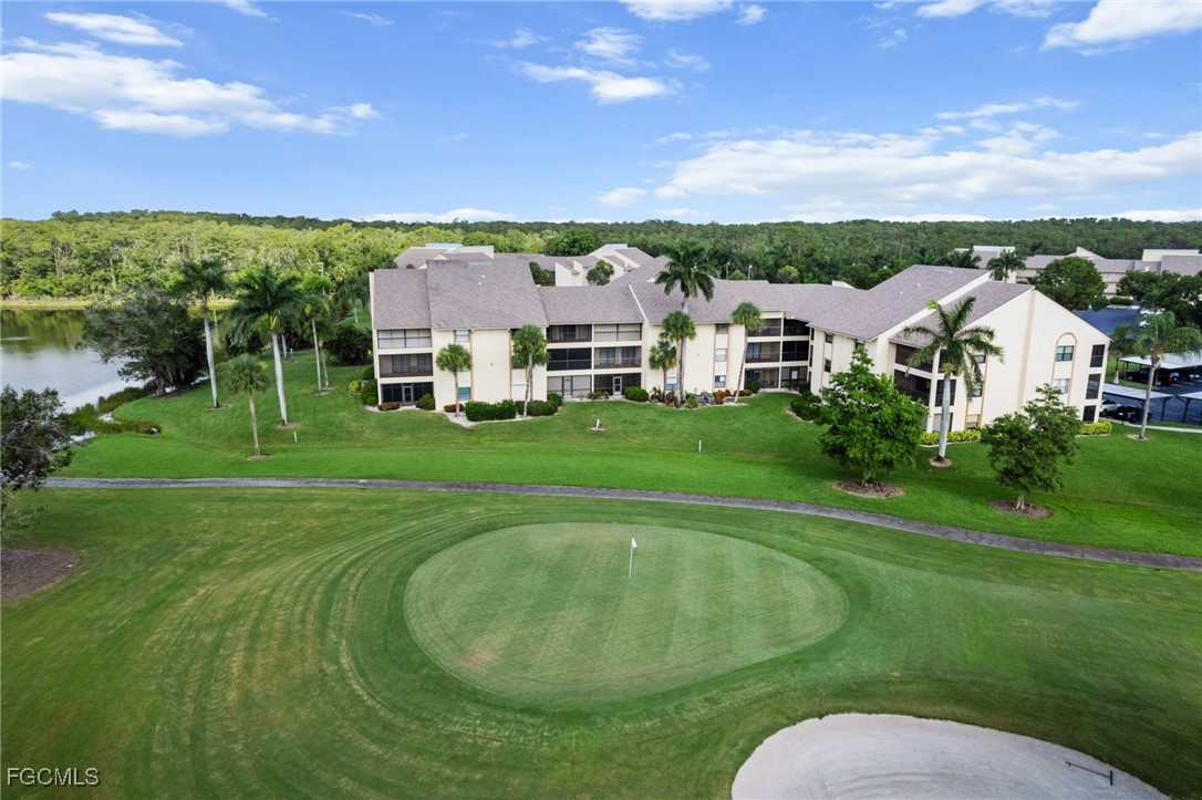 13276 White Marsh Lane, Unit 3533 Fort Myers, FL 33912 - Photo 29 of 31 a view of a house with a big yard and large trees