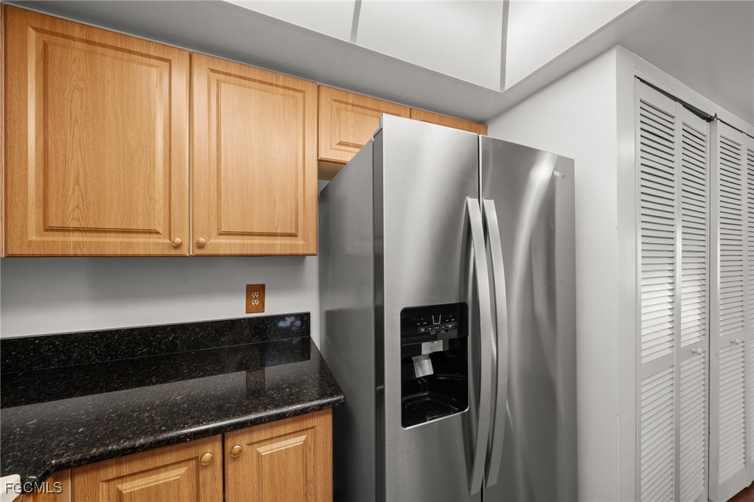 13276 White Marsh Lane, Unit 3533 Fort Myers, FL 33912 - Photo 6 of 31 a kitchen with stainless steel appliances granite countertop a refrigerator and a sink