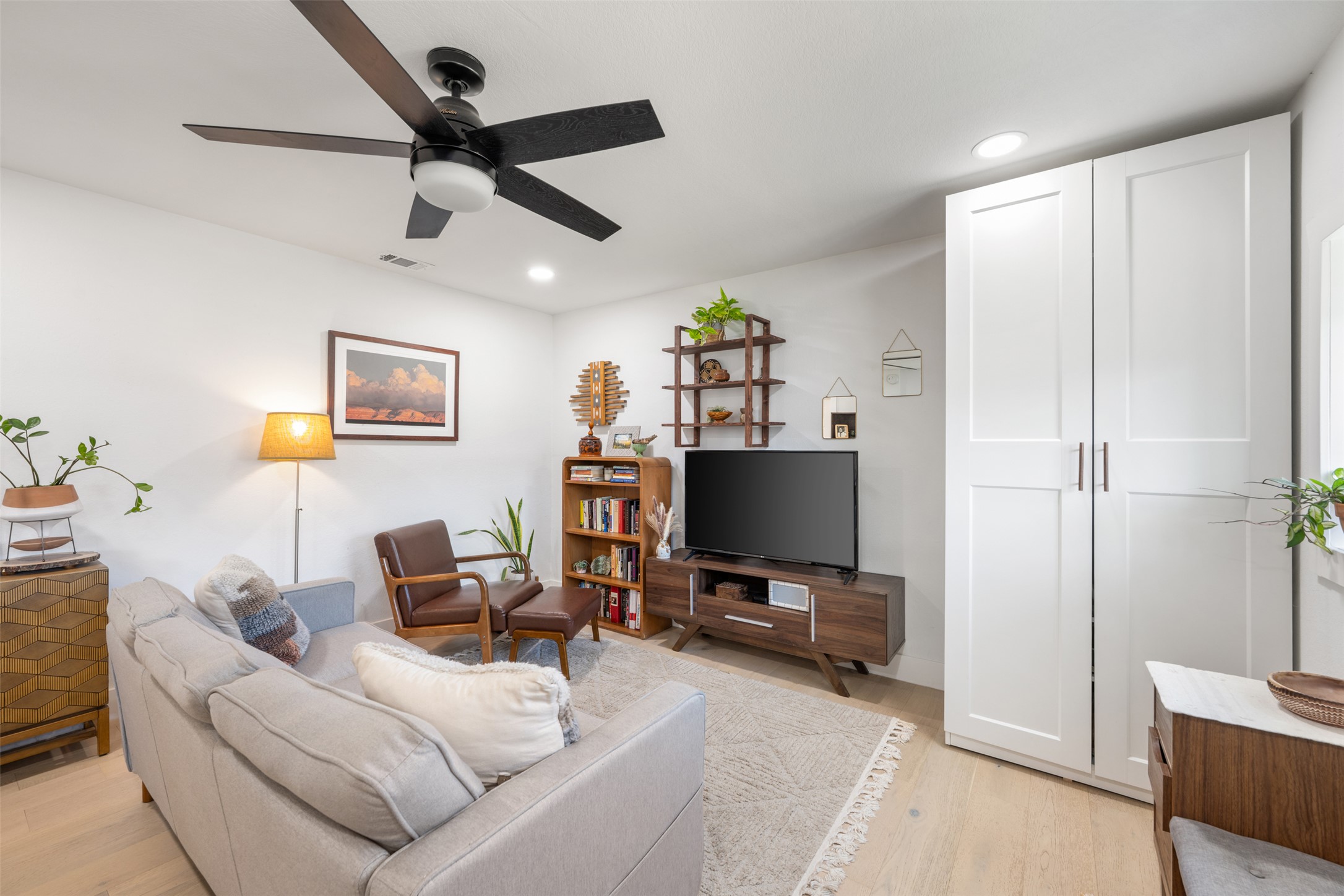 1616 Webberville Road, Unit A Austin, TX 78721 - Photo 9 of 35 Living area with light wood-style flooring, recessed lighting, and ceiling fan