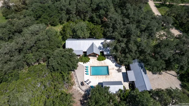 an aerial view of a house with outdoor space
